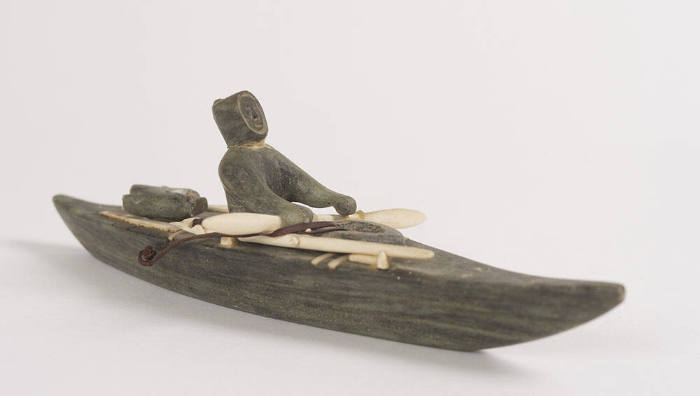 Man in Kayak with Hunting Implements