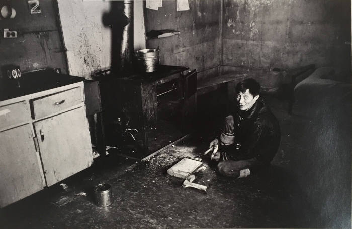 Untitled (Man Cutting Bone on Floor)